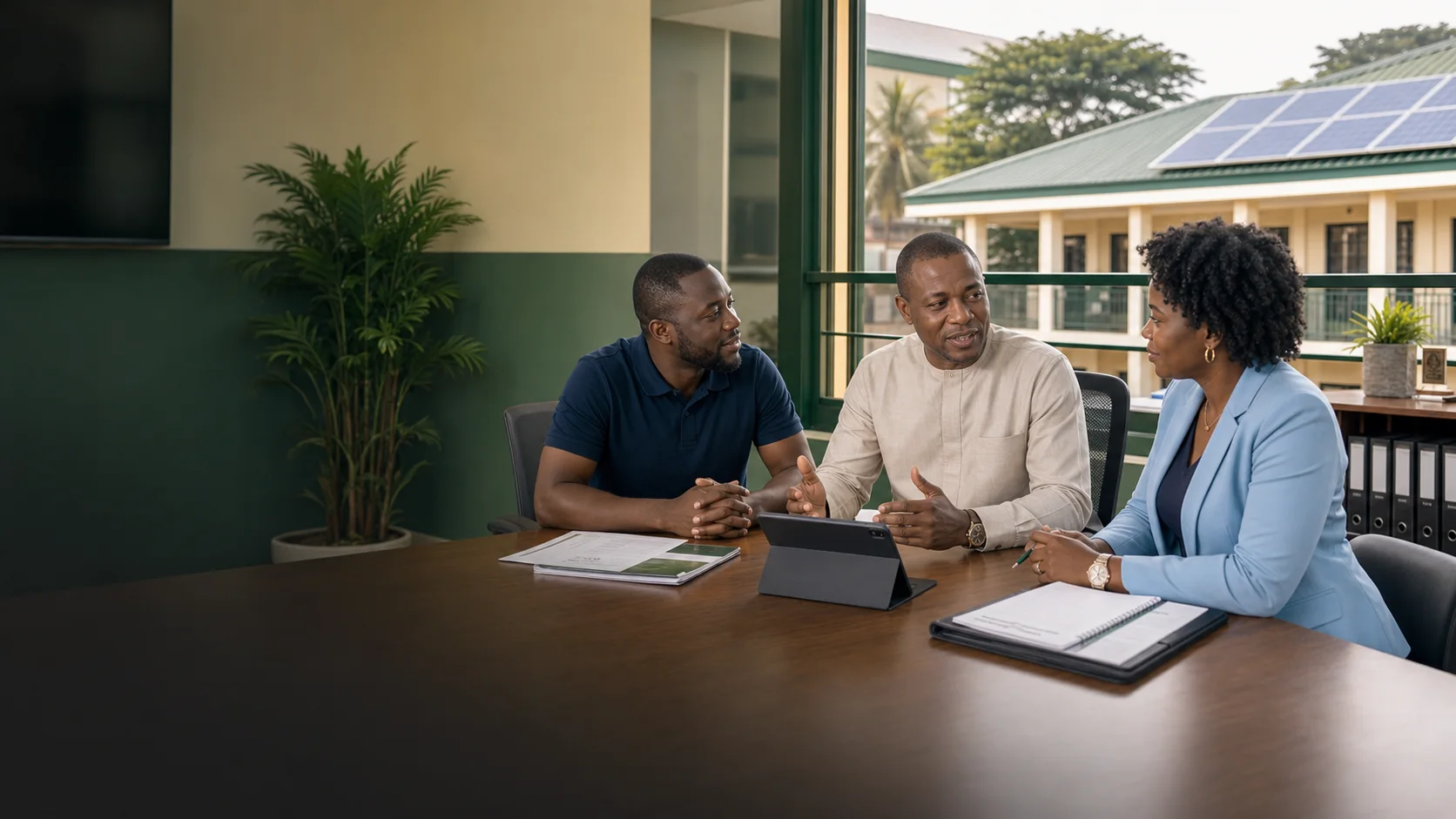 School leaders discussing solar questions with an advisor beside a solar-powered campus